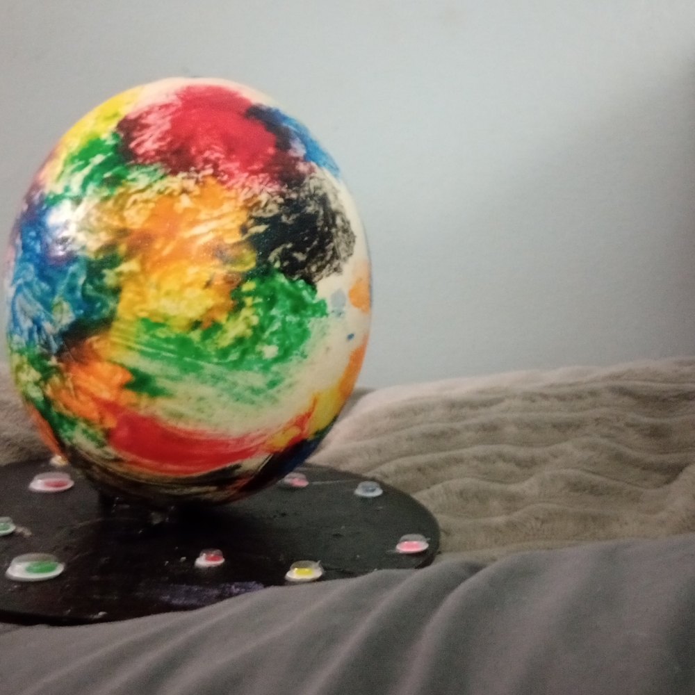 a tue life ostrich egg painted with unicorn spit style